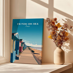 Frinton-on-Sea Travel Poster – Essex Coastline Beach Huts & Prom Art displayed next to a vase of flowers.