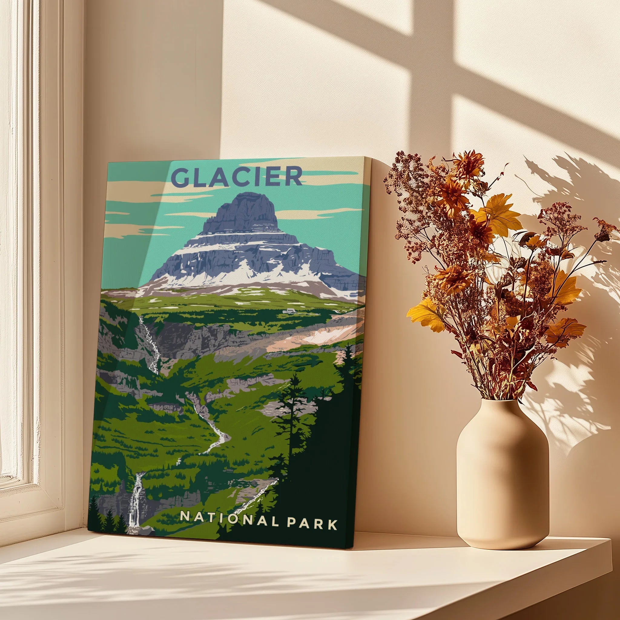 Glacier National Park travel poster print on windowsill with vase of autumn flowers