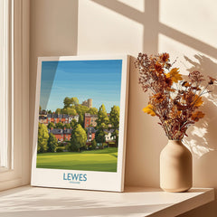 Lewes England travel poster print on windowsill with dried flowers in a vase and sunlight