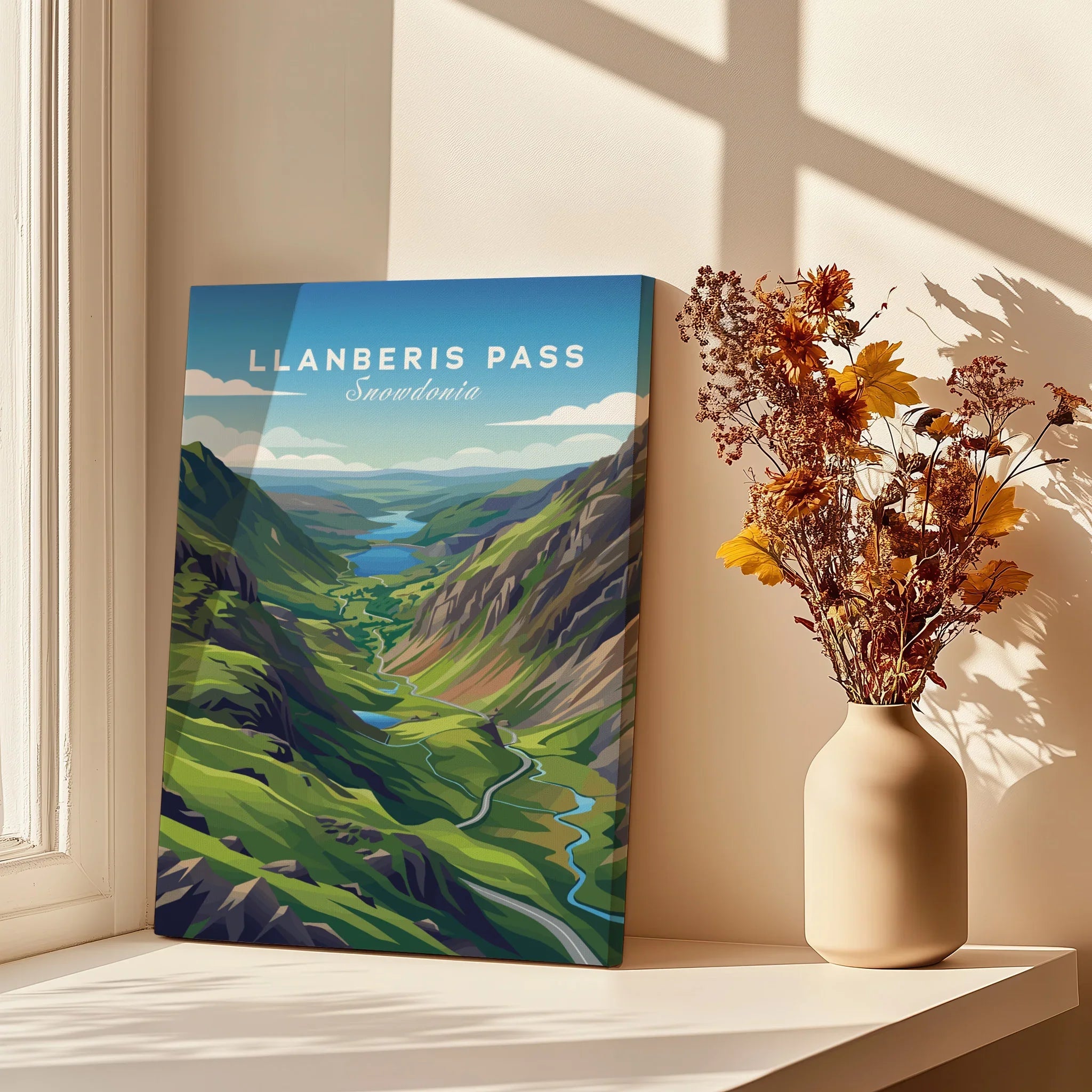 Llanberis Pass Snowdonia travel poster canvas print beside vase with dried flowers in sunlight