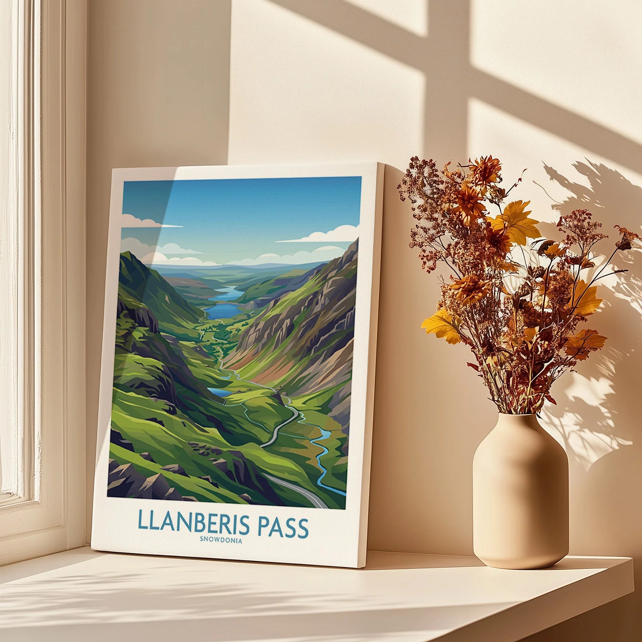 Llanberis Pass travel poster print on windowsill with vase of dried flowers, natural light