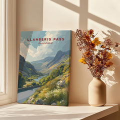 Llanberis Pass Snowdonia travel poster print on windowsill with vase of dried flowers.