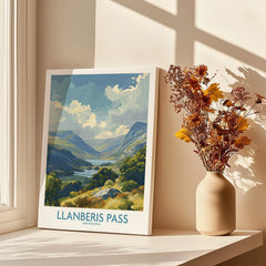 Llanberis Pass Snowdonia travel poster print on a windowsill with vase of dried flowers