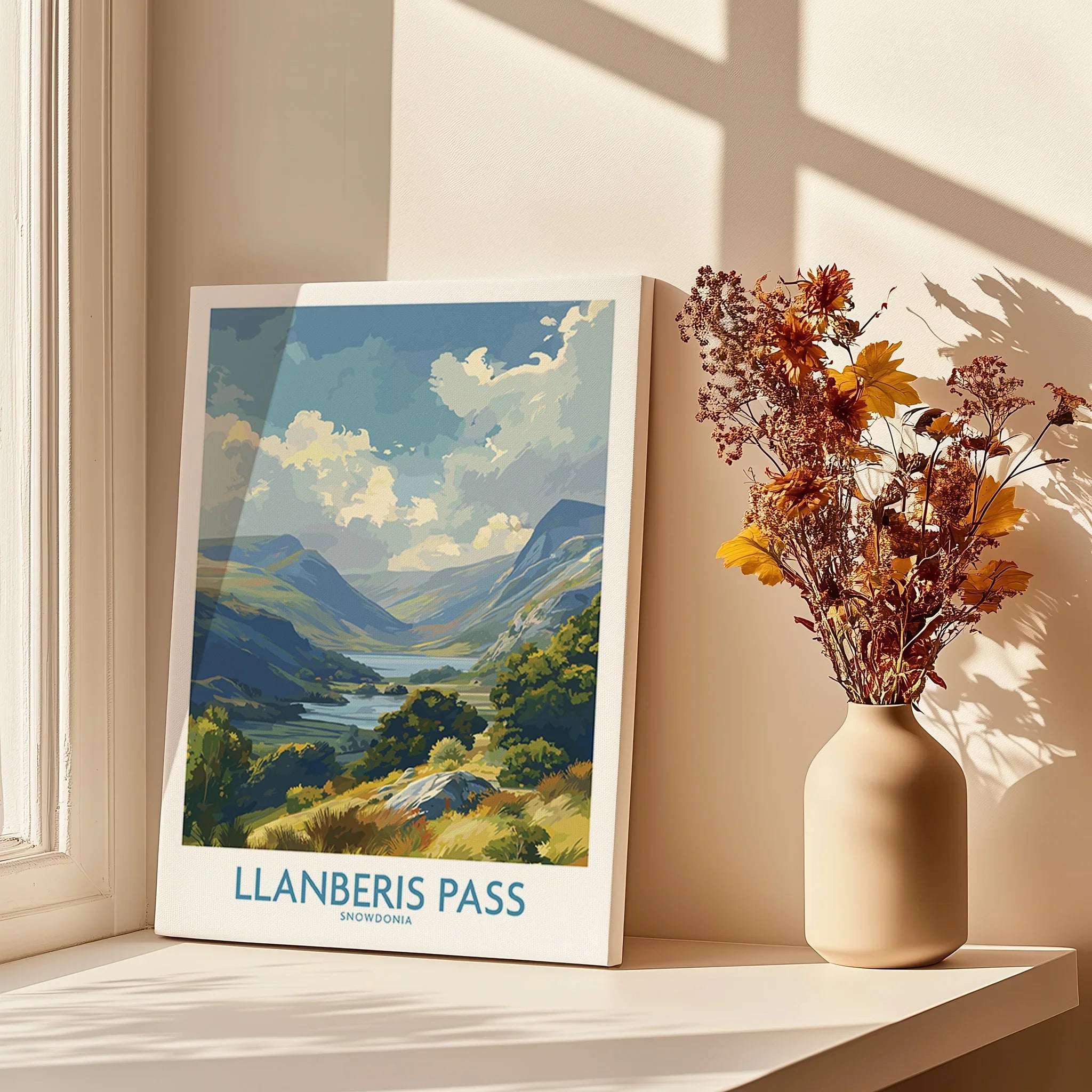 Llanberis Pass Snowdonia travel poster print on a windowsill with vase of dried flowers