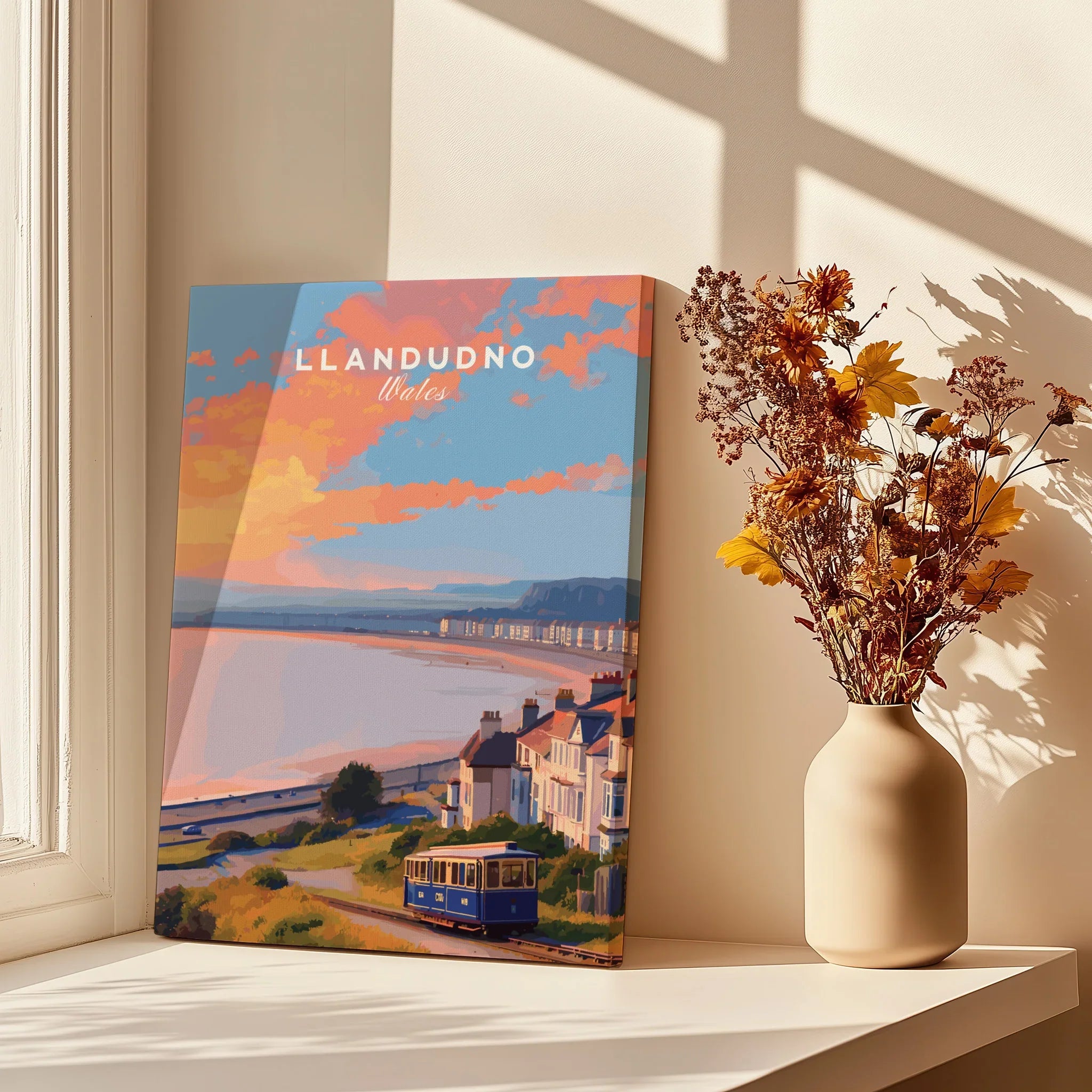 Llandudno Wales travel poster canvas print on sunny windowsill with dried flowers in vase