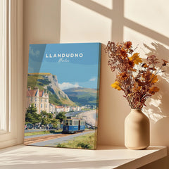 Llandudno Wales travel poster canvas print with vintage tram, next to vase of dried flowers on windowsill