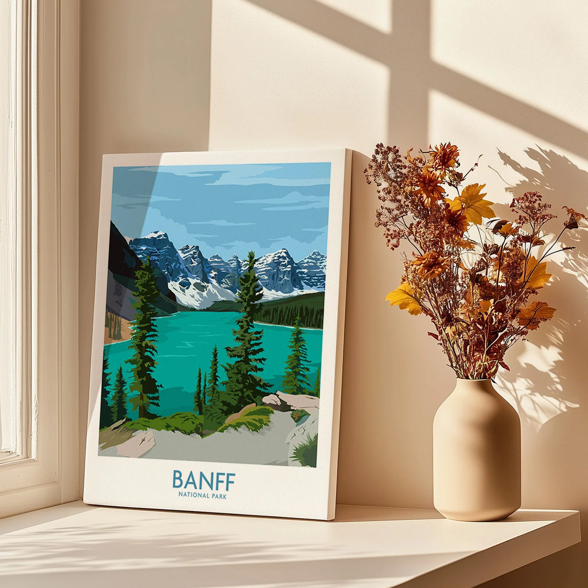 Banff National Park travel poster print by a window with shadows and a vase of dried flowers