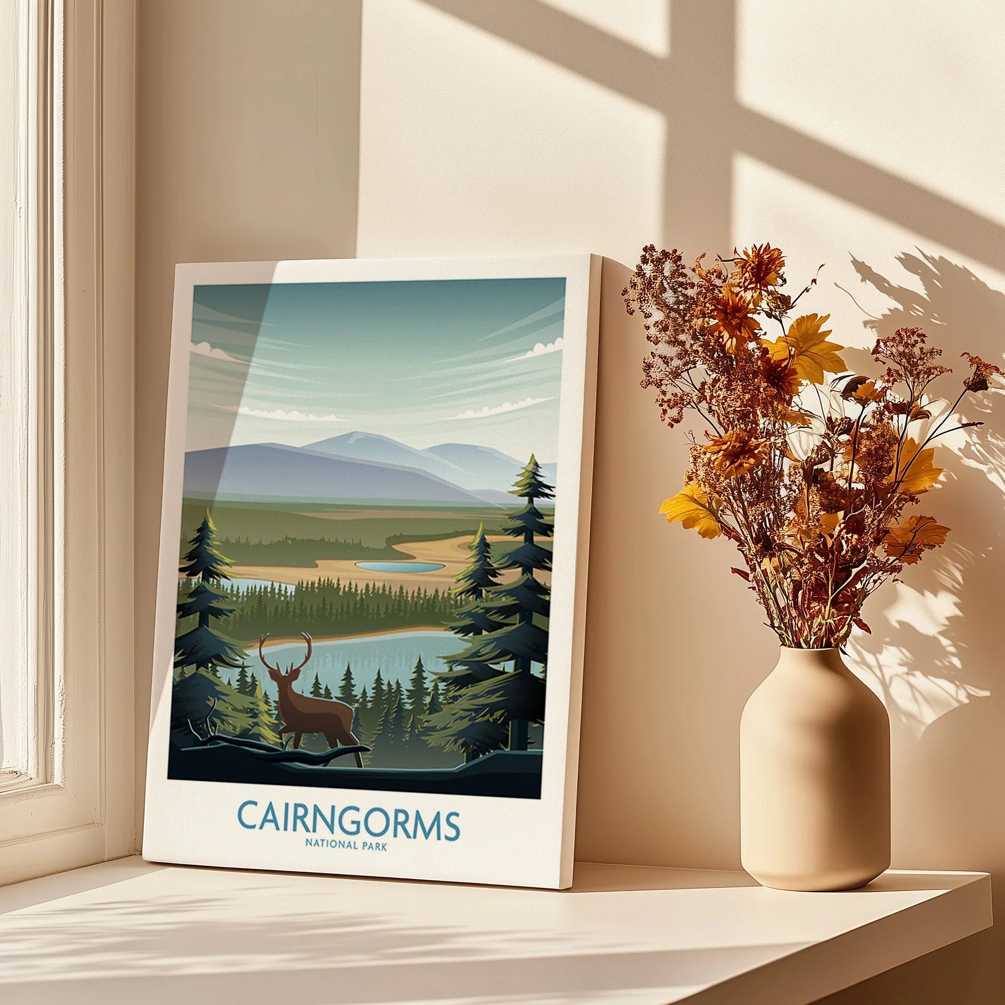 Cairngorms National Park art print with landscape and deer, on a windowsill with dried flowers.
