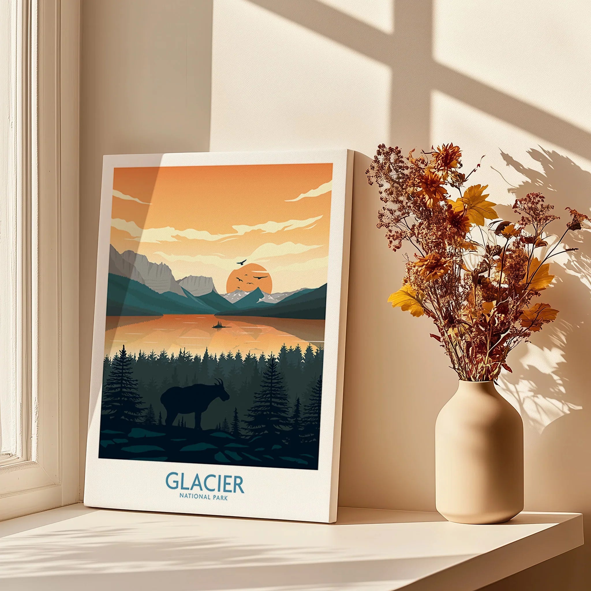 Glacier National Park wall art print on a windowsill with vase of dried flowers, warm sunlight