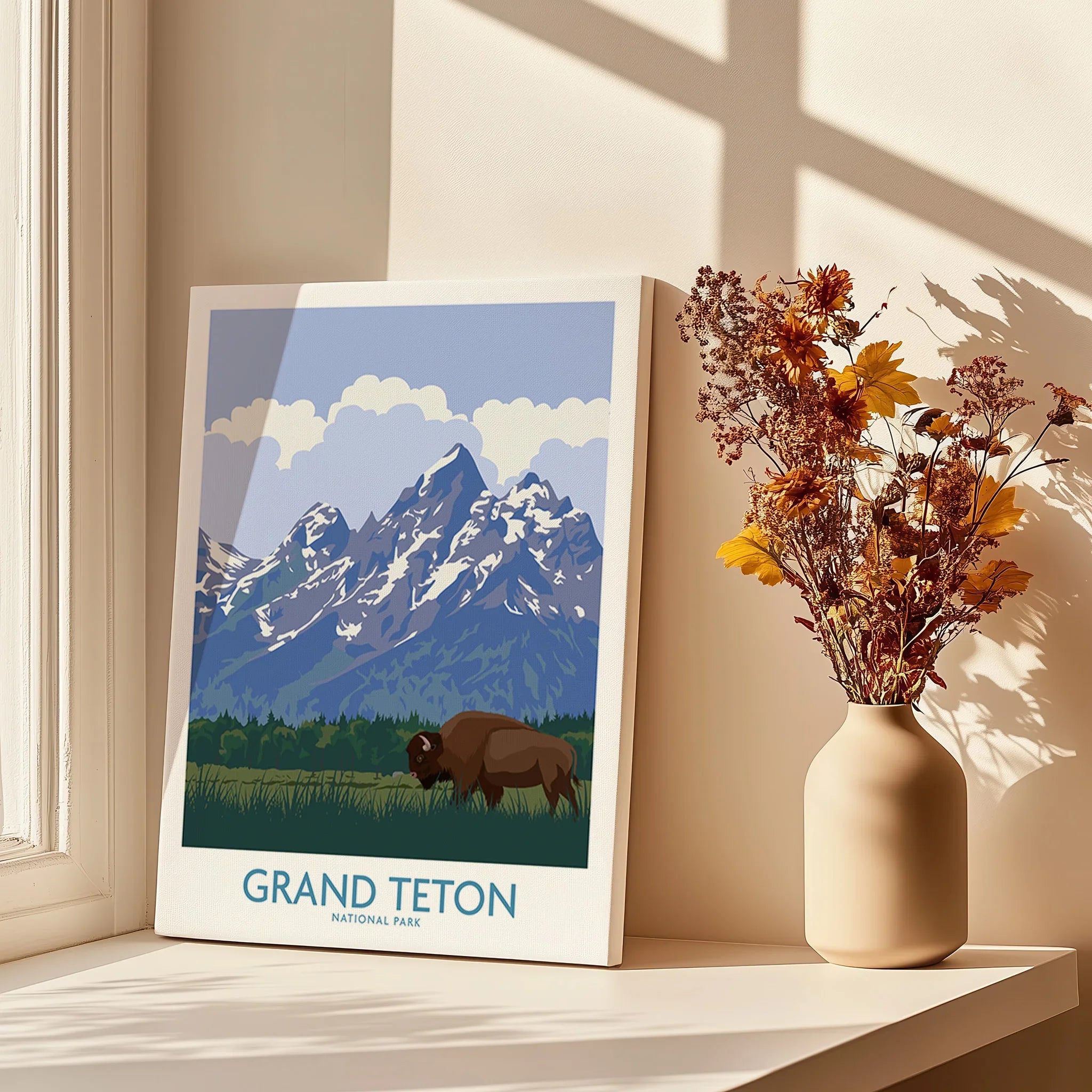 Grand Teton National Park art print with bison, displayed by a vase of dried flowers on a sunny windowsill.