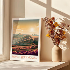 North York Moors travel poster art print on windowsill with vase of dried flowers