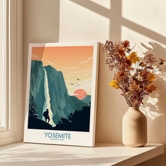 Yosemite National Park canvas print with waterfall and hiker, next to vase of dried flowers on windowsill