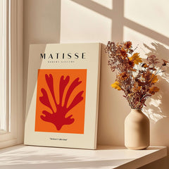 Matisse Art Prints - Red Leaf Abstract Orange Square Poster displayed next to a vase of flowers in a sunlit room.