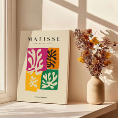 Matisse Art Prints - Four Block Abstract Leaves Poster displayed beside a vase with flowers and sunlight.