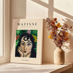 Matisse Art Prints - Pensive Woman Poster displayed on a shelf beside a vase with dried flowers.