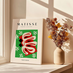 Matisse Art Prints -  Abstract Shape Red Green Poster displayed beside a vase with flowers in a sunlit room.