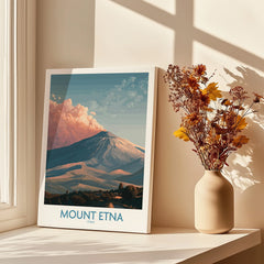 Mount Etna travel poster print on table by sunlit window with vase of dried flowers
