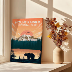 Mount Rainier National Park print with bear and sunset, next to vase of dried flowers on window ledge.
