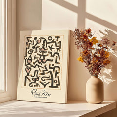 Paul Klee Comedians Handbill Abstract Figures Poster Modern Art Print displayed on a table beside a vase with flowers.