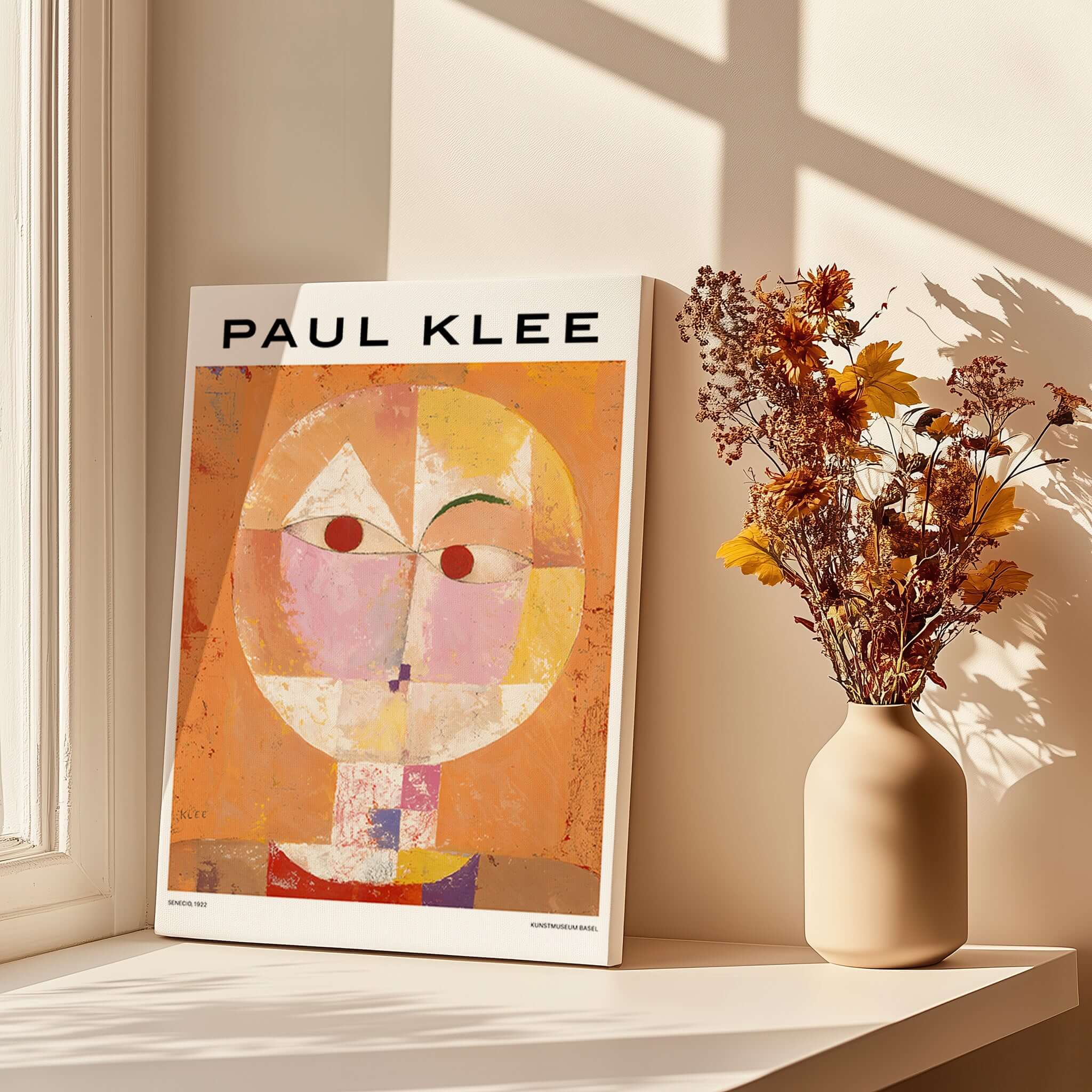 Paul Klee Senecio Head of Man Abstract Portrait Poster Art Print displayed beside flowers in a vase.