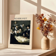 Rembrandt Anatomy Lesson Dr Tulp 1632 Group Portrait Art Print Dutch Master Poster displayed on a table with flowers.