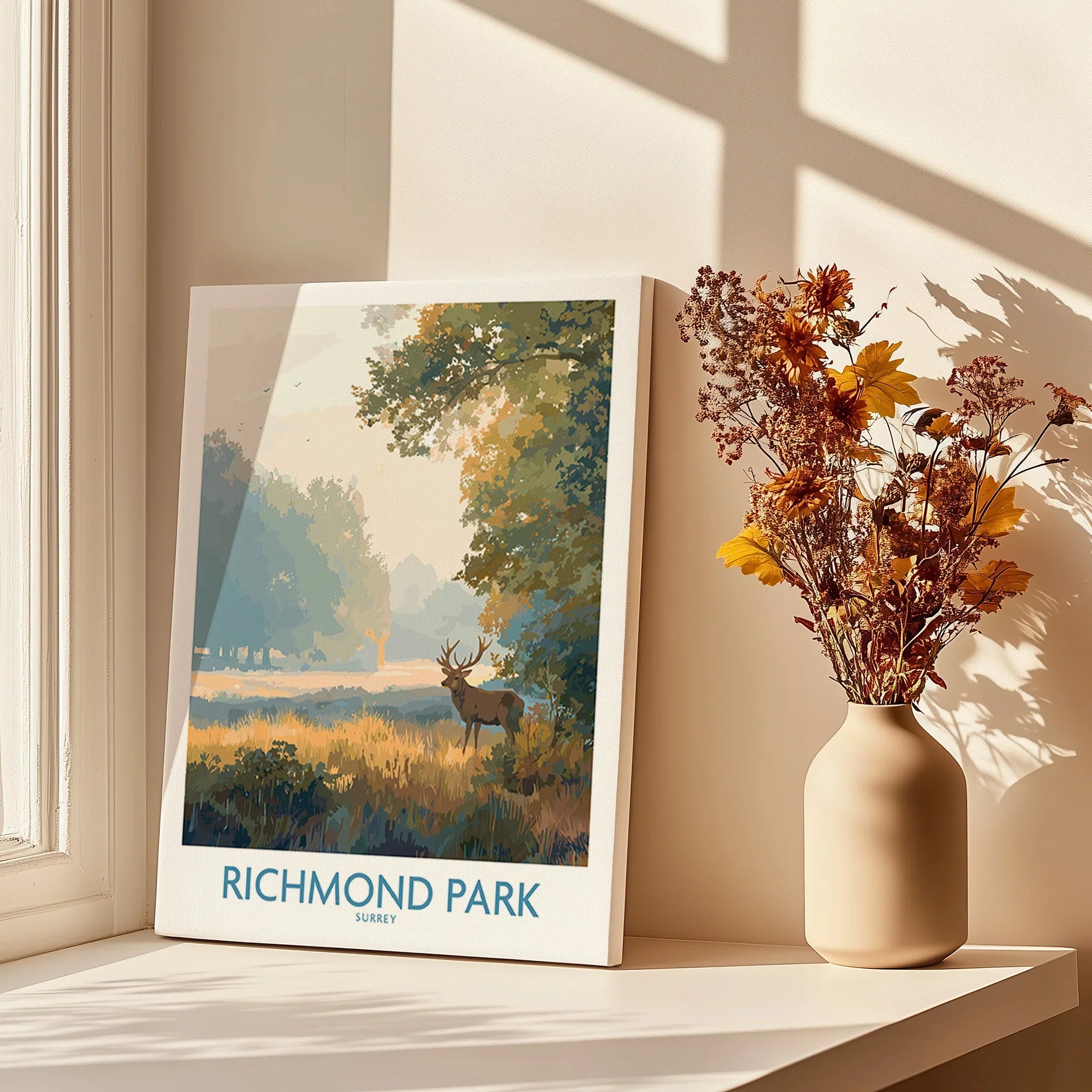 Richmond Park travel poster print on shelf by window with shadows and dried flowers
