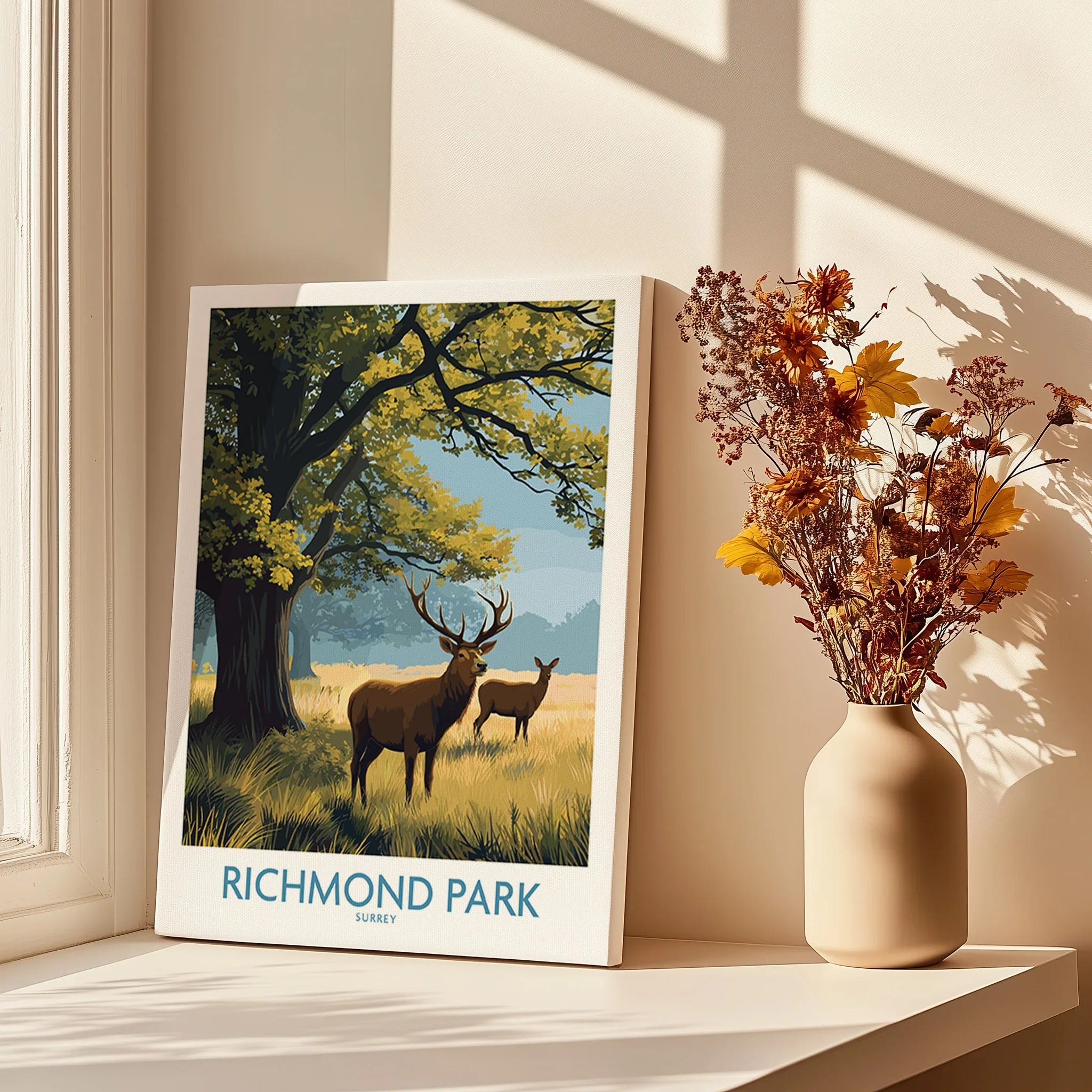 Richmond Park art print with deer, tree, and grass in sunlight beside vase of dried flowers