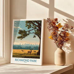 Richmond Park wall art print with deer, tree and city skyline by a vase of dried flowers on a sunlit windowsill