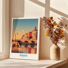Rimini Italy Poster | Vintage Vespa & Historic Bridge Canvas Print displayed on a table by a window with flowers.