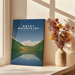 Rocky Mountains National Park print on canvas in sunlight near vase with dried flowers