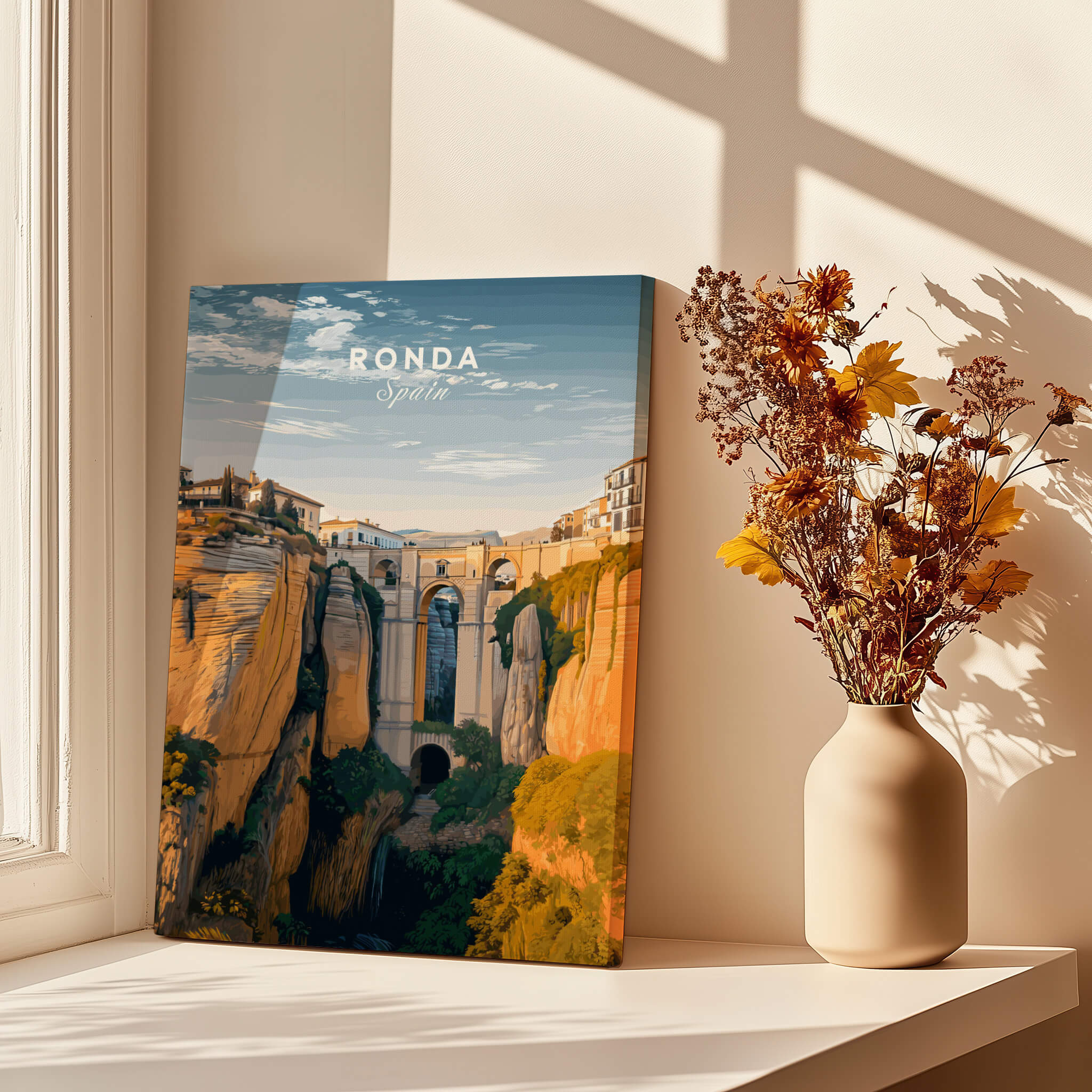 Ronda Spain Wall Art Print | Historic White Village Cliffside Travel Poster displayed in a bright room with flowers.