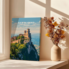 San Marino Wall Art Print | Mount Titano Citadel Travel Poster displayed in a bright room with flowers.