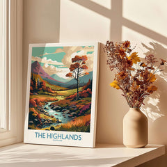 The Highlands Scotland Art Print displayed on a table beside a vase of flowers, showcasing vibrant colors and scenic landscape.