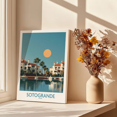 Sotogrande Spain Canvas Print | Mediterranean Waterfront Scenery Poster displayed with flowers in a vase.