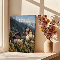 Vaduz Liechtenstein travel poster canvas on windowsill with vase of dried flowers, sunlight