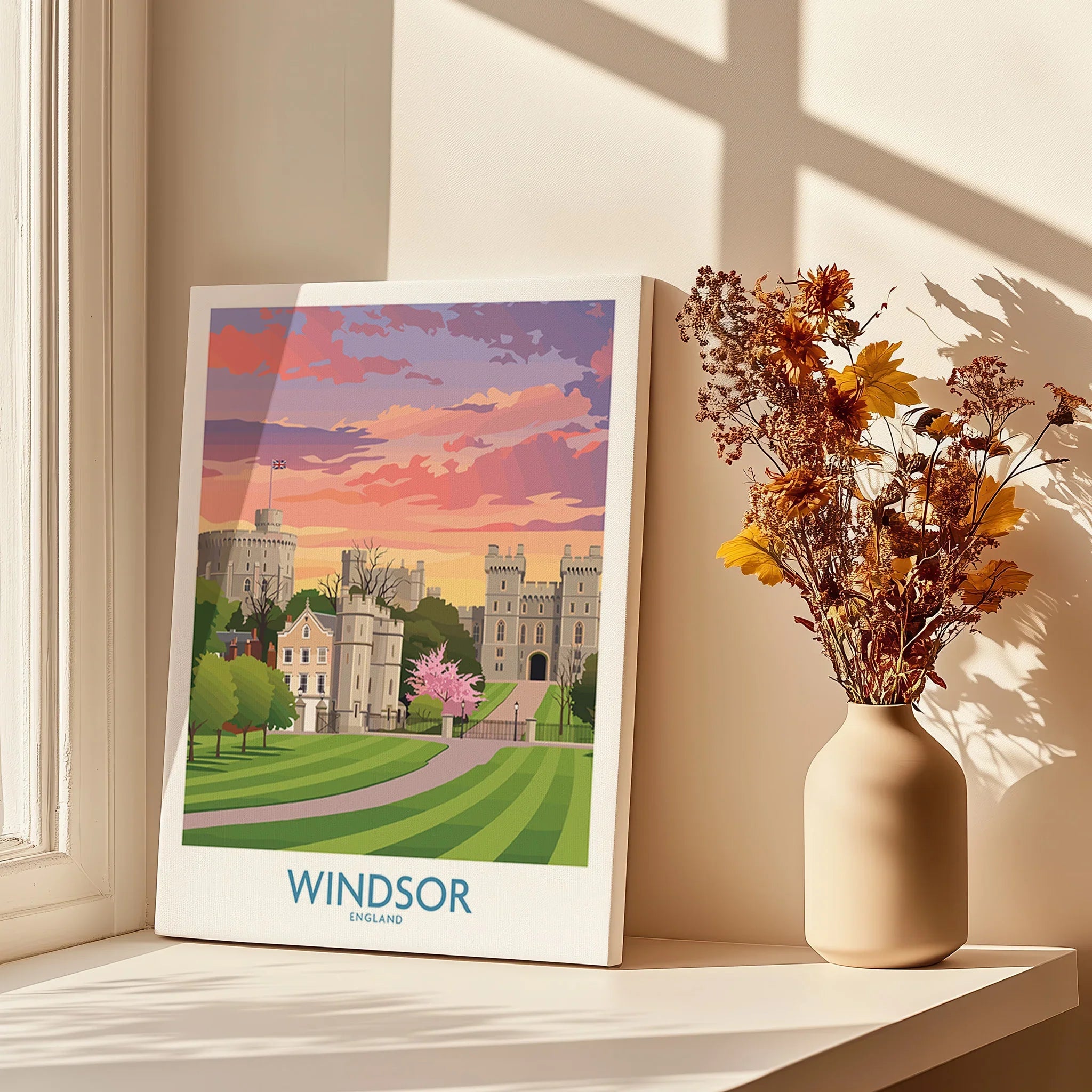 Windsor England travel poster print on window sill with vase of dried flowers in sunlight