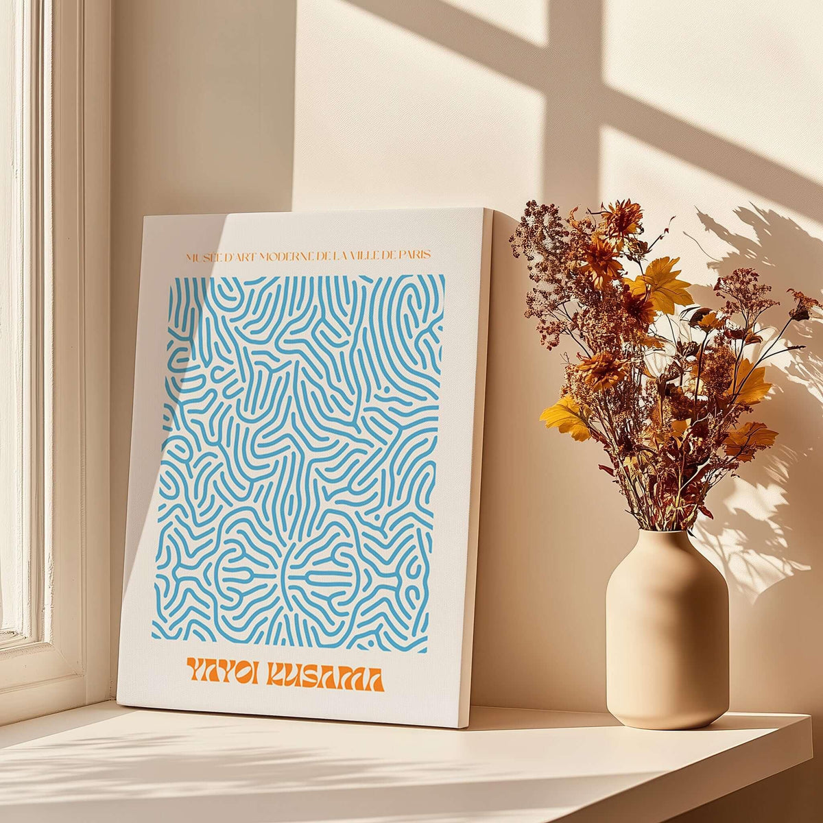 Yayoi Kusama Blue Infinity Net Pattern Abstract Art Print Paris Exhibition Poster displayed near a vase with flowers.