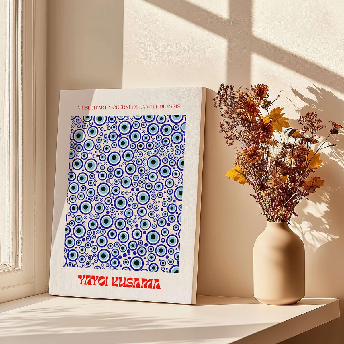 Yayoi Kusama Evil Eye Pattern Blue Contemporary Art Print Poster Paris Wall Decor displayed on a sunny window sill.