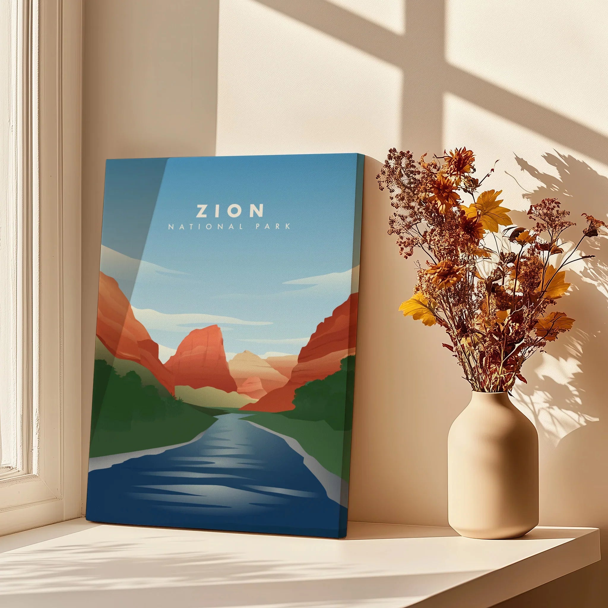 Zion National Park canvas wall art in window light next to vase with dried flowers.