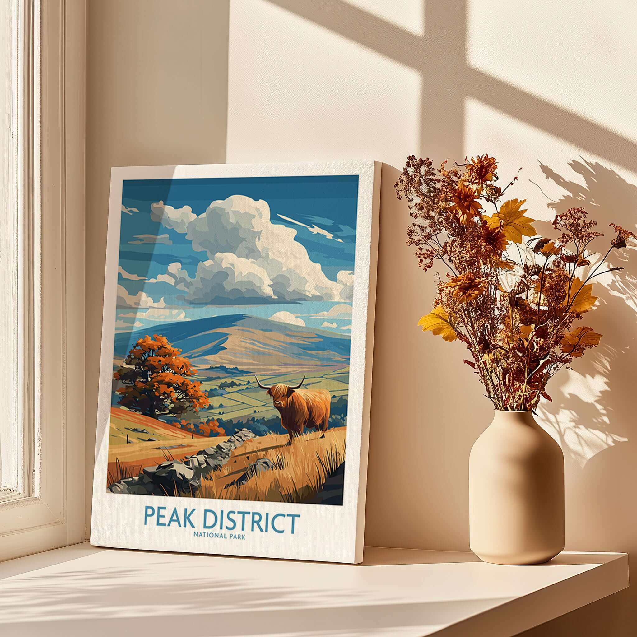 Peak District National Park Highland Cow Art Print | Derbyshire Landscape Poster displayed in a sunlit room with flowers.