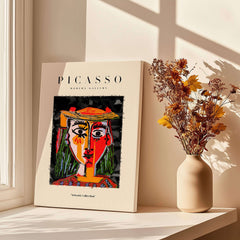 Picasso Woman in Hat Red Yellow Face Portrait Poster Colorful Abstract Artwork Print displayed near flowers.
