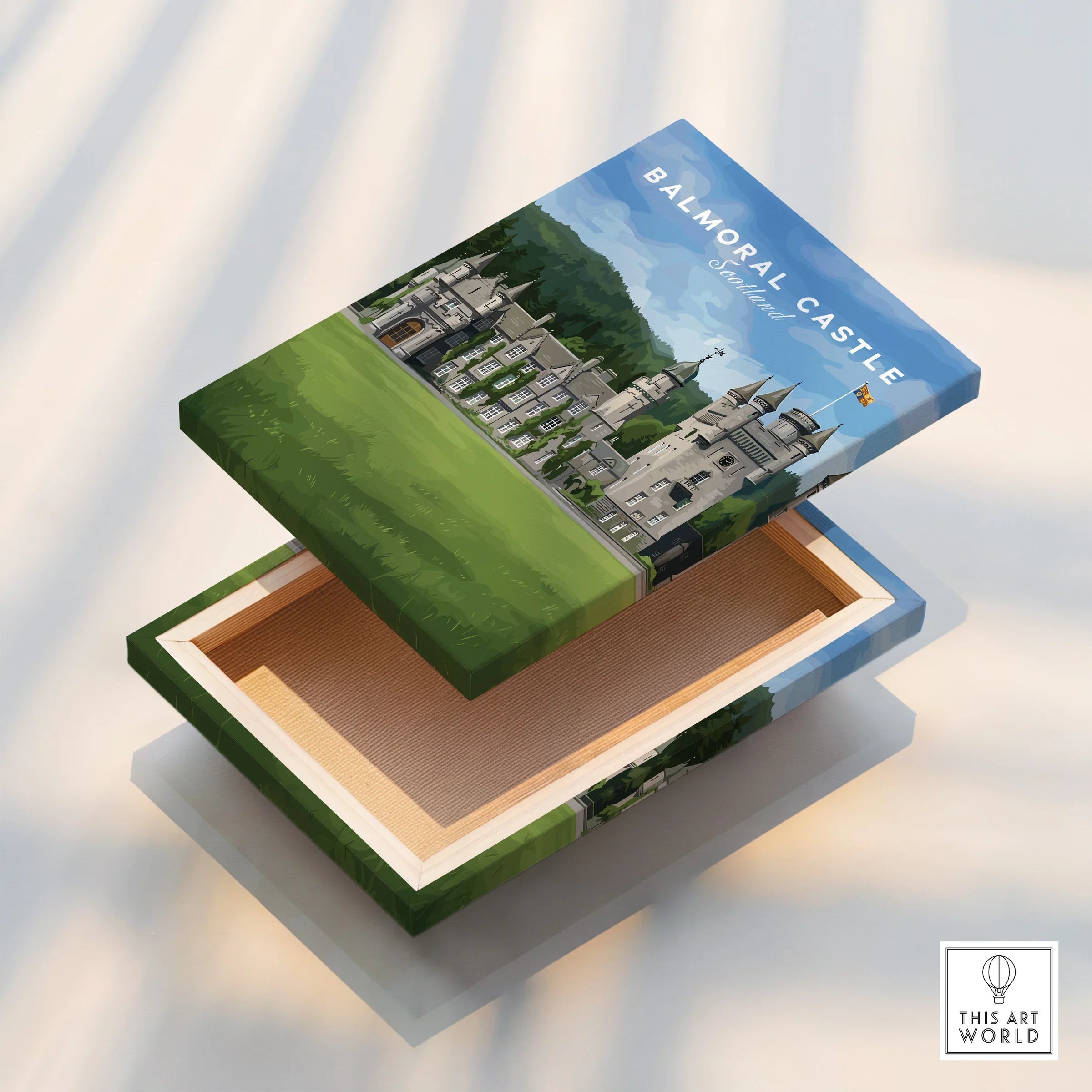 Balmoral Castle Scotland travel art print on an open decorative wooden box, sunlight shadows.