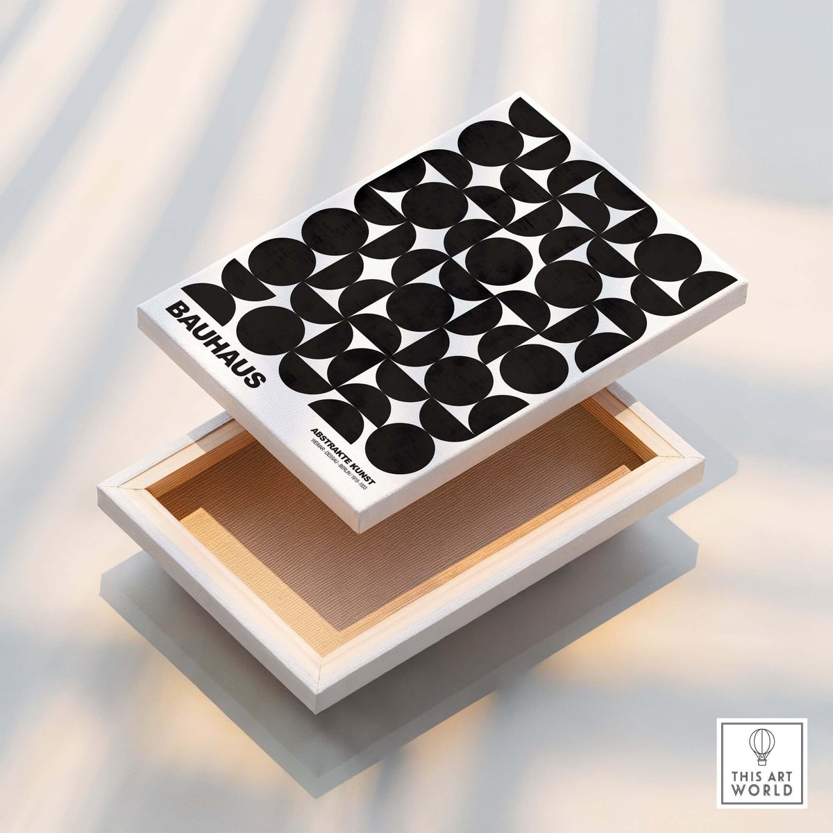 Bauhaus Exhibition Prints - Geometric Circle Shapes Art Print Black White Pattern displayed on a wooden box with black shapes.