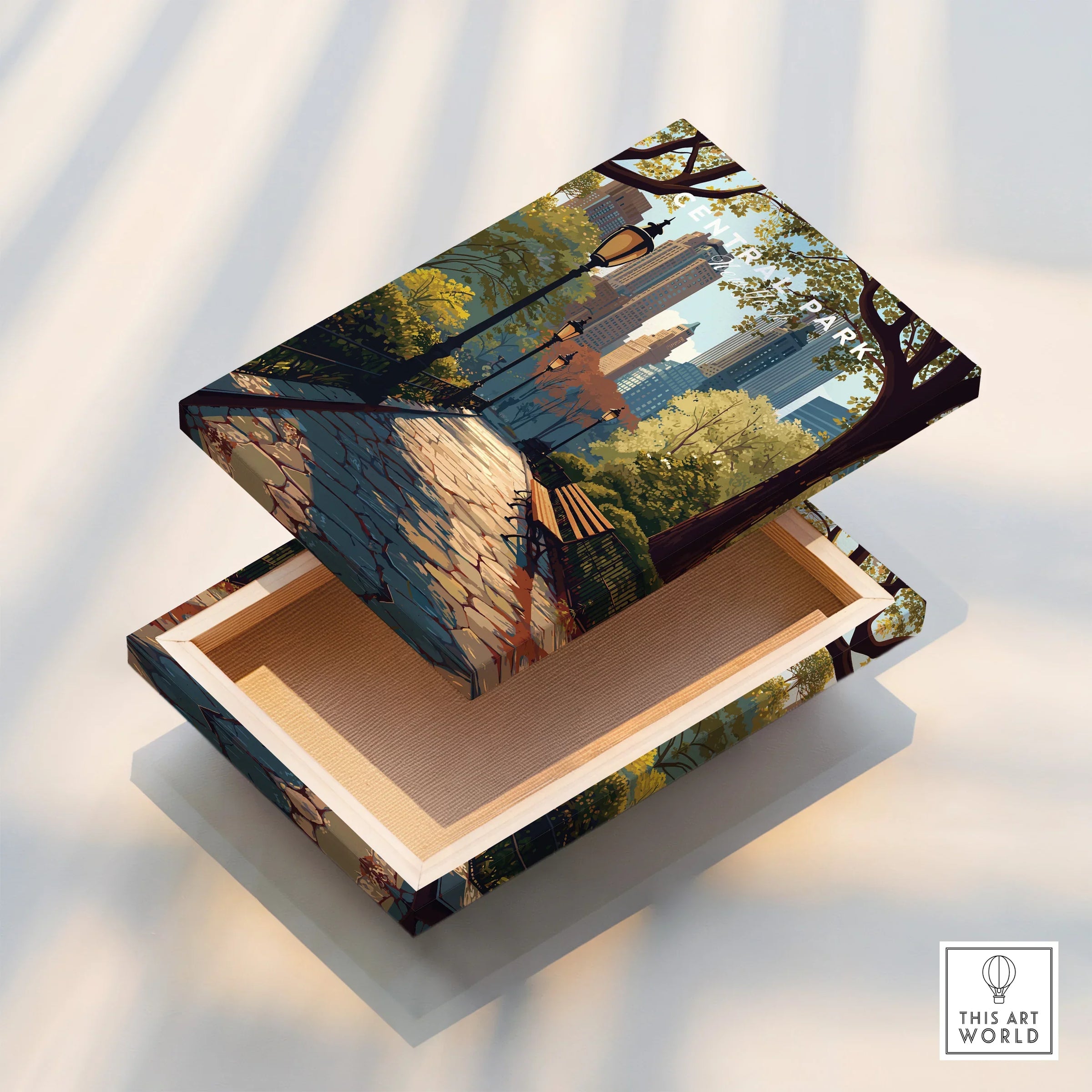 Canvas print box with Central Park and city skyline illustration, park benches, and trees.