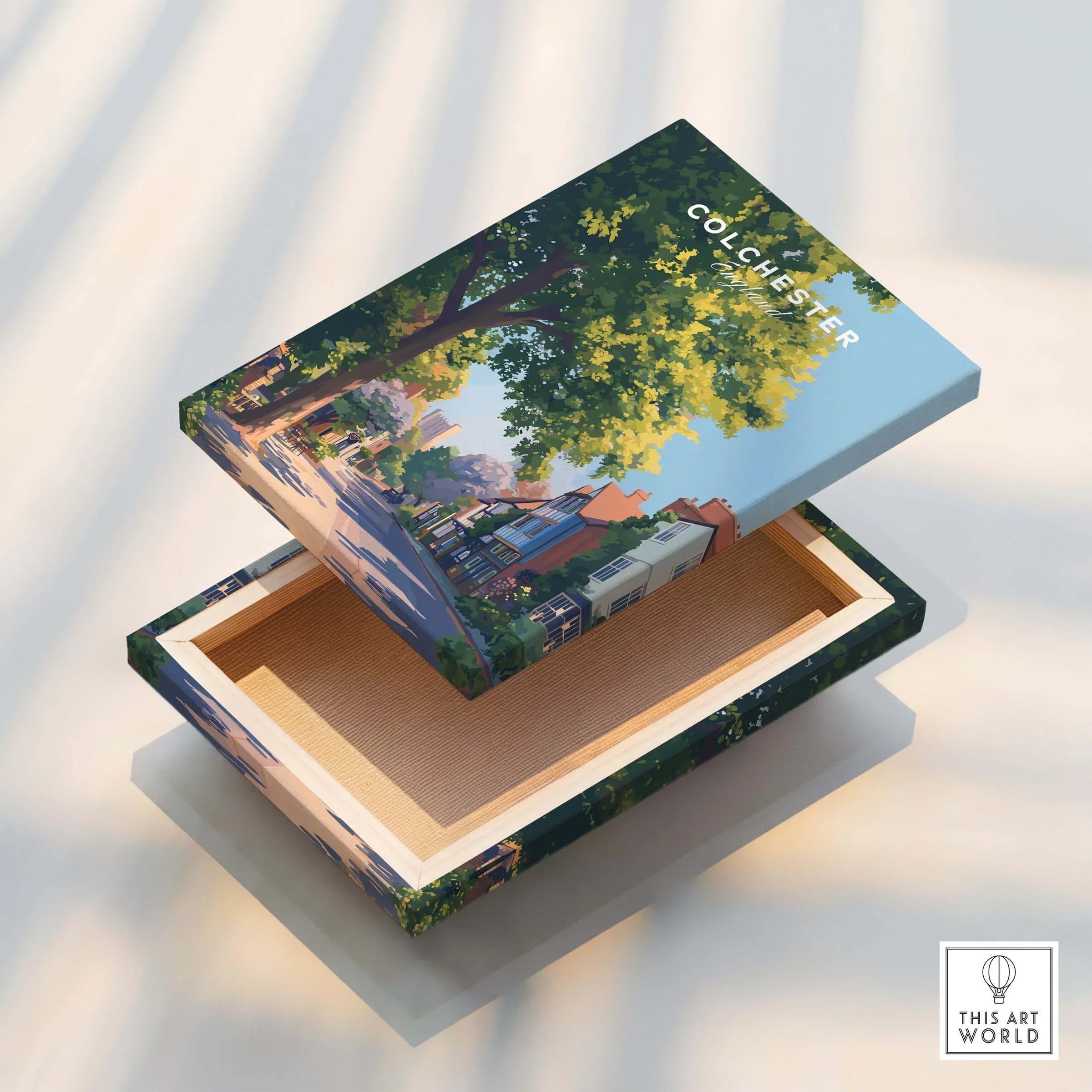 Colchester illustrated travel art on a floating canvas print box, featuring tree-lined street and colorful houses.