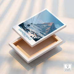 Grindelwald Switzerland Poster | Snowy Alps Mountain Scene Canvas Print displayed on a box with a snowy mountain backdrop.