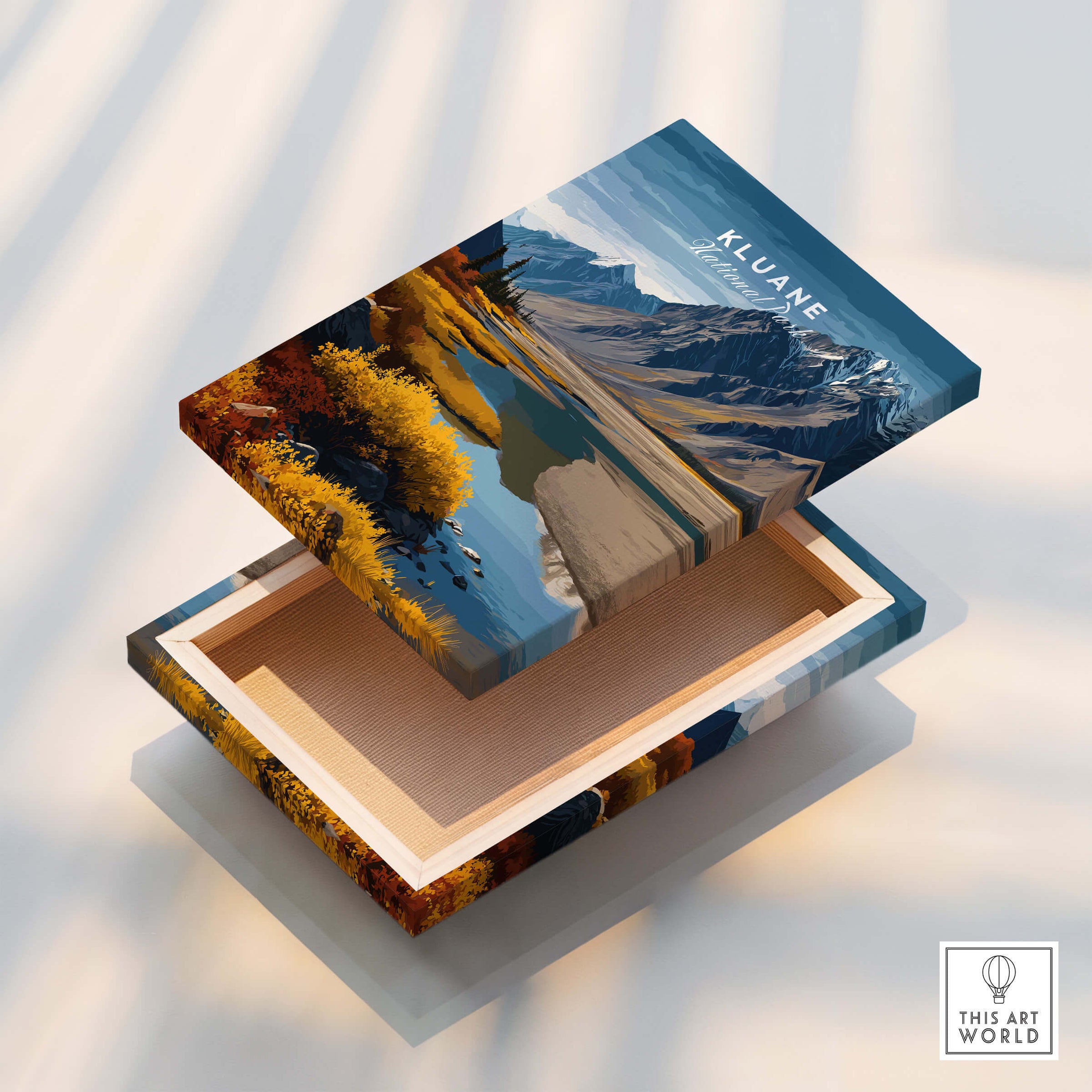Kluane Travel Poster National Park Canada | Yukon Valley Wall Art Print display on a decorative box featuring fall landscapes.