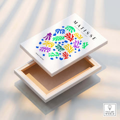 Matisse Art Prints - Colourful Scattered Abstract Leaves Dots Poster displayed on a wooden box with vibrant leaf designs.