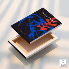 Matisse Art Prints -  Dance Blue Figures Poster displayed on a canvas, showcasing vibrant blue figures and a coral design.