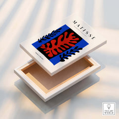 Matisse Art Prints -  Red Coral Black Leaves Blue Frame Poster displayed on a stylish box, featuring abstract design.